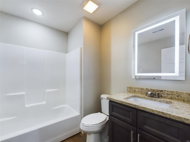 full bathroom featuring toilet, vanity, hardwood / wood-style flooring, and shower / bath combination