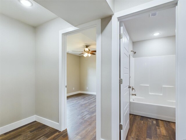 bathroom featuring ceiling fan, shower / bathing tub combination, and hardwood / wood-style floors