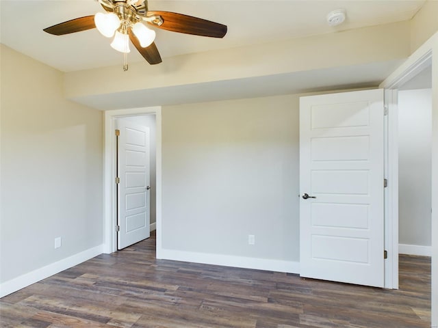 unfurnished bedroom featuring ceiling fan and dark wood-type flooring