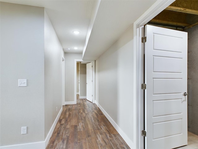 corridor with hardwood / wood-style flooring