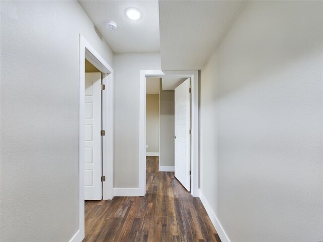 hallway featuring dark hardwood / wood-style flooring