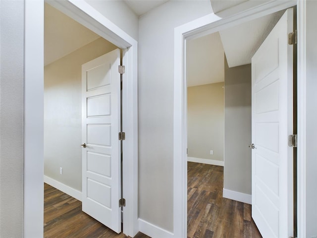 corridor with dark hardwood / wood-style floors