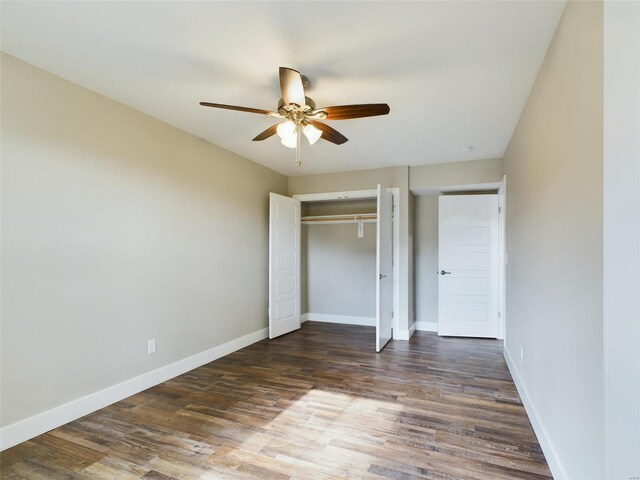 unfurnished bedroom featuring a closet, dark hardwood / wood-style floors, and ceiling fan