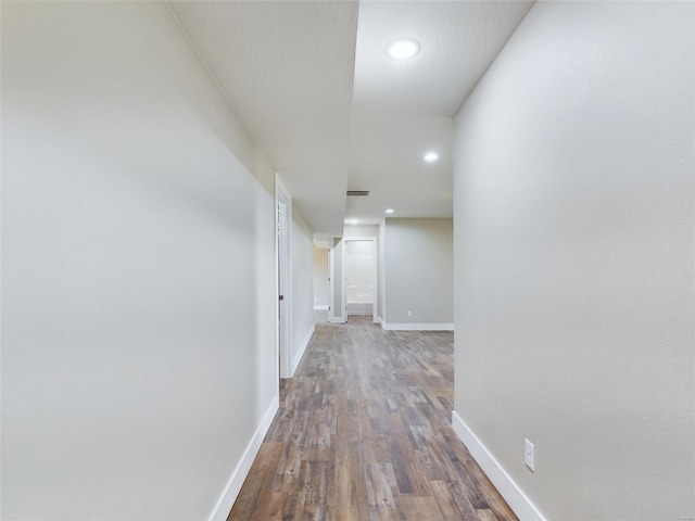 corridor with hardwood / wood-style floors