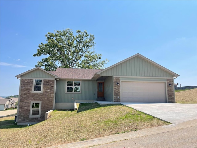 single story home with a garage and a front lawn