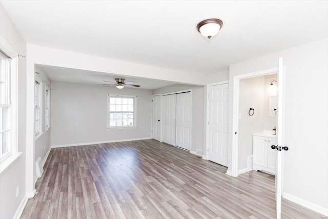 unfurnished room featuring light hardwood / wood-style floors and ceiling fan