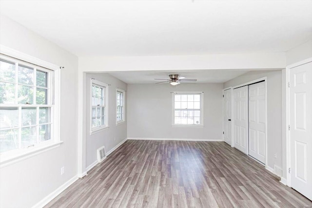 unfurnished room featuring ceiling fan, plenty of natural light, and light hardwood / wood-style flooring