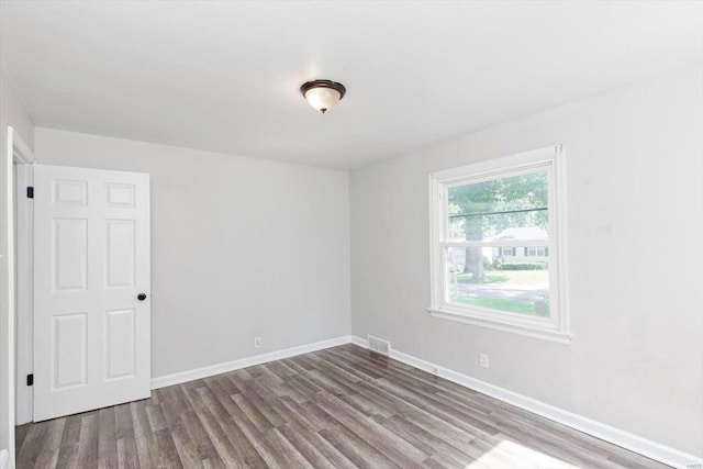 spare room with hardwood / wood-style floors