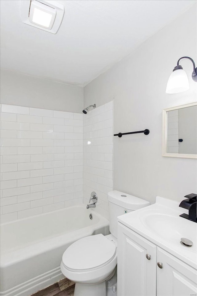 full bathroom with toilet, vanity, hardwood / wood-style floors, and tiled shower / bath