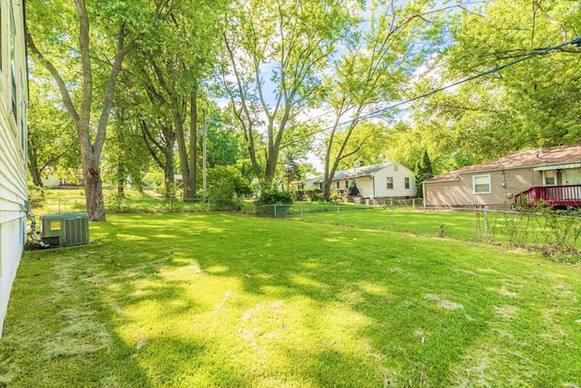 view of yard featuring central AC unit and a deck