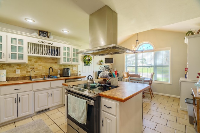 kitchen with sink, electric range, tasteful backsplash, white cabinetry, and island exhaust hood