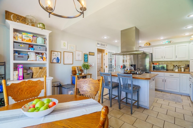 tiled dining area featuring an inviting chandelier