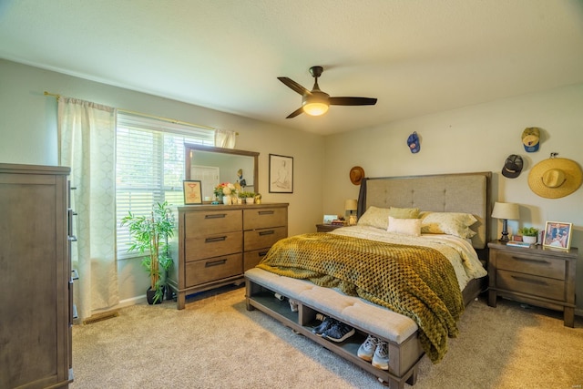 bedroom featuring ceiling fan and light carpet