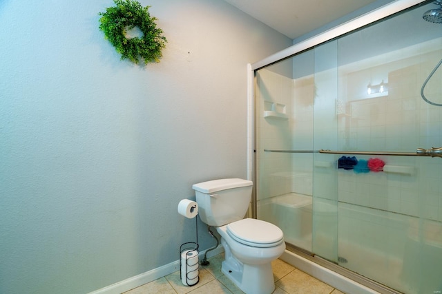 bathroom featuring tile patterned flooring, an enclosed shower, and toilet