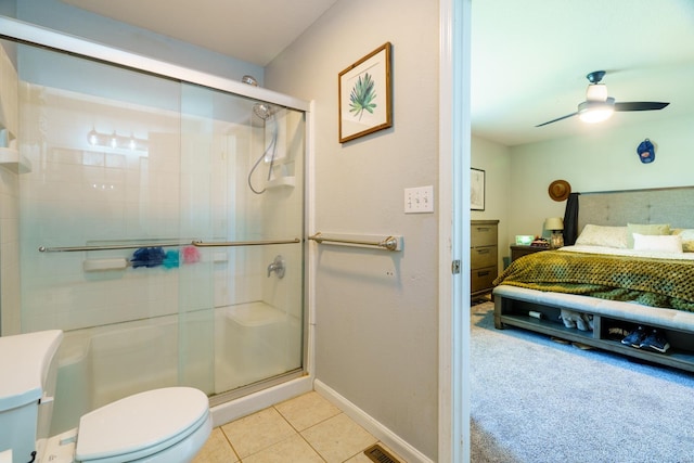 bathroom with ceiling fan, toilet, walk in shower, and tile patterned floors