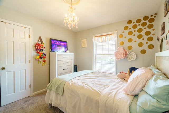 bedroom with carpet and a chandelier