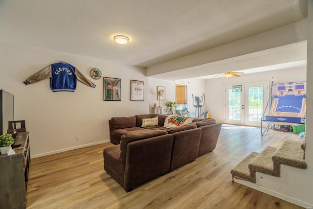 living room featuring light hardwood / wood-style flooring, ceiling fan, and french doors