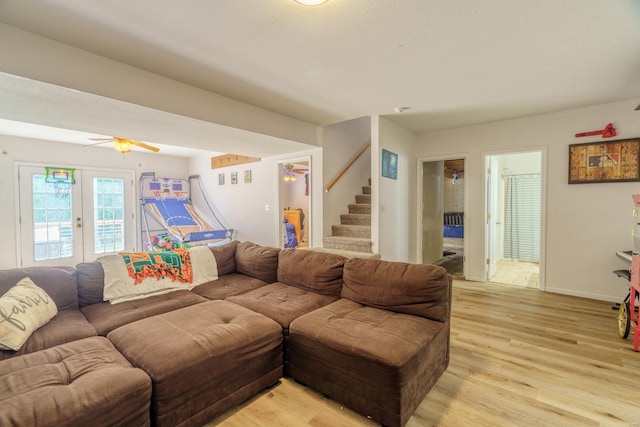 living room with light wood-type flooring, french doors, and ceiling fan