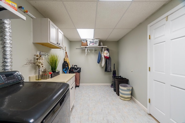 interior space with light hardwood / wood-style flooring, washer / clothes dryer, and cabinets