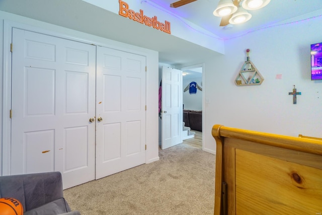 bedroom with light colored carpet, a closet, and ceiling fan