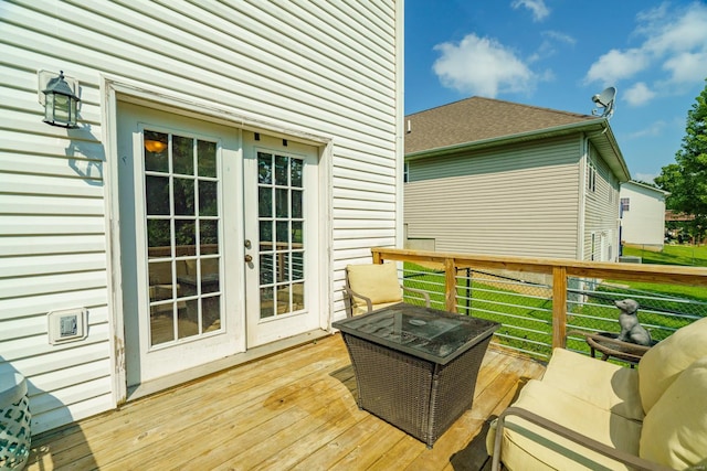 wooden terrace featuring french doors and a yard