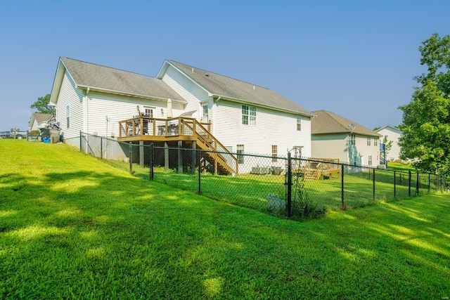 rear view of house with a yard and a deck