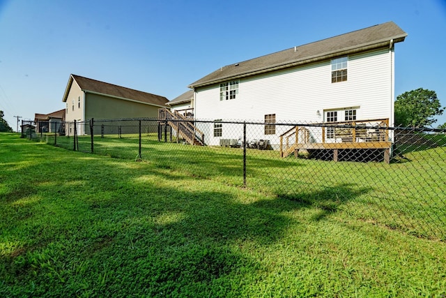 back of house featuring a yard and a wooden deck