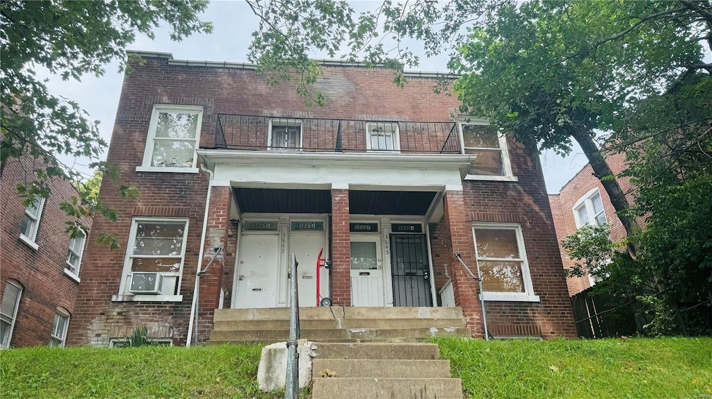 view of front of house featuring a balcony