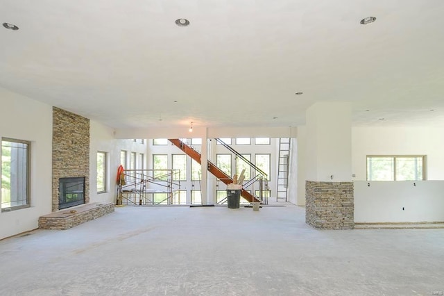 unfurnished living room featuring a stone fireplace