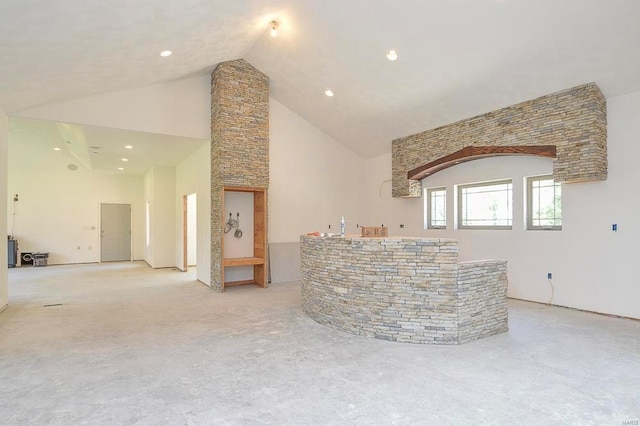 interior space featuring light colored carpet, recessed lighting, and high vaulted ceiling