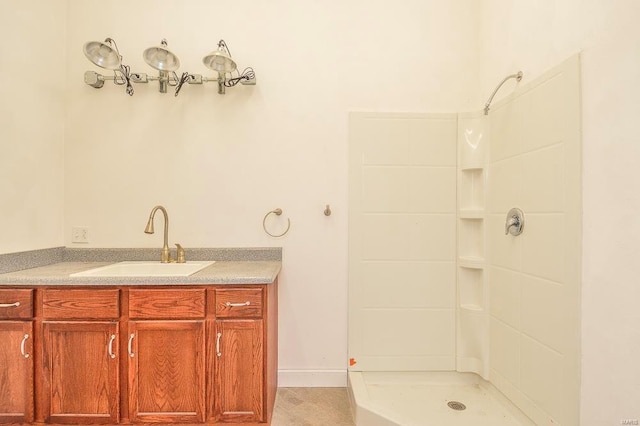 bathroom with walk in shower and vanity