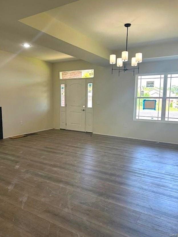 entryway featuring a chandelier and wood-type flooring