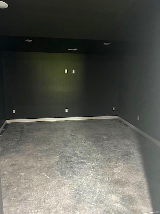 unfurnished room with concrete floors