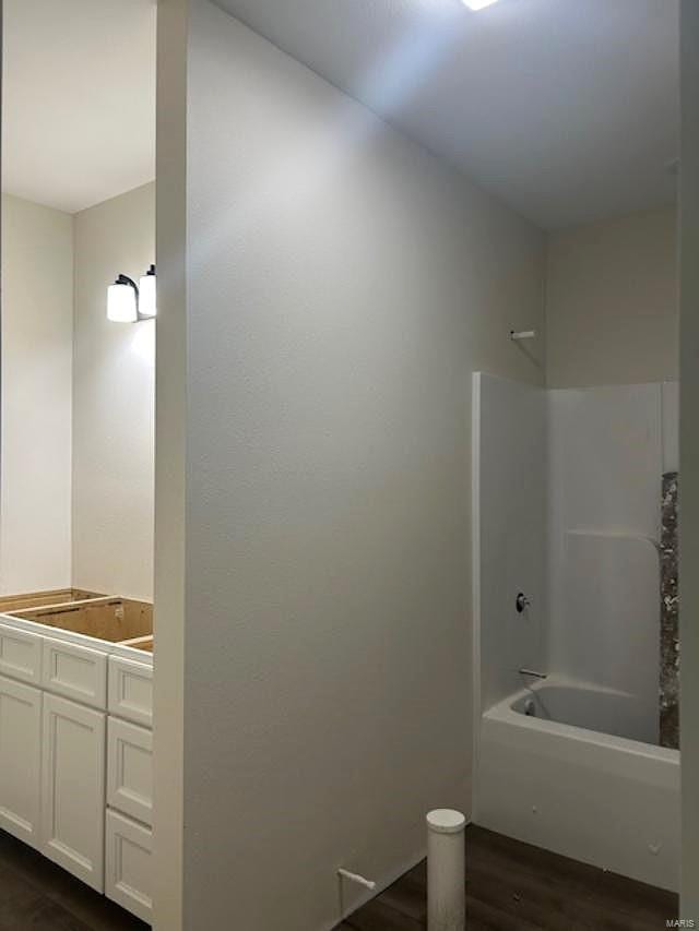 bathroom with vanity, tub / shower combination, and wood-type flooring