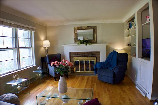 living room with light wood-type flooring and built in shelves