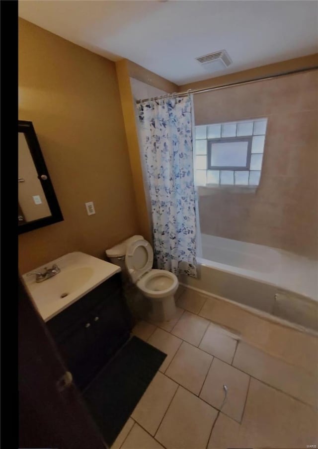 full bathroom featuring shower / bath combination with curtain, tile patterned floors, toilet, and vanity