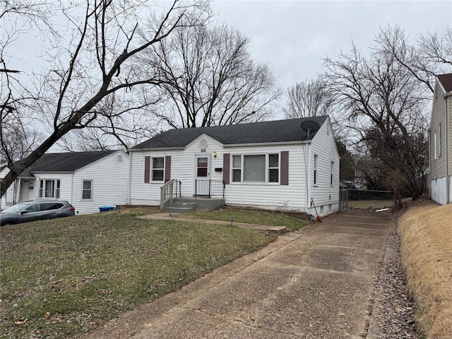 bungalow featuring driveway and a front lawn