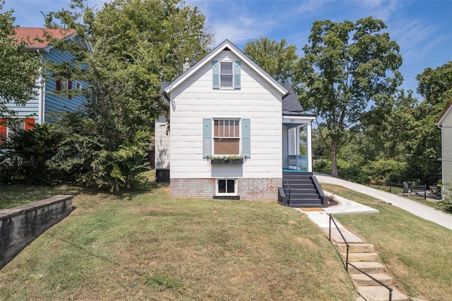 back of house with stairway and a yard