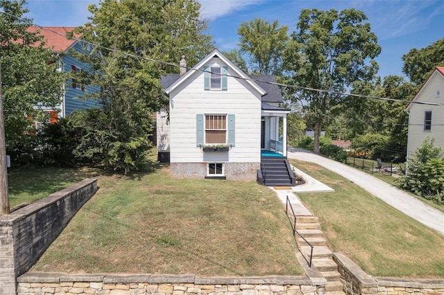 bungalow with a shingled roof and a front lawn