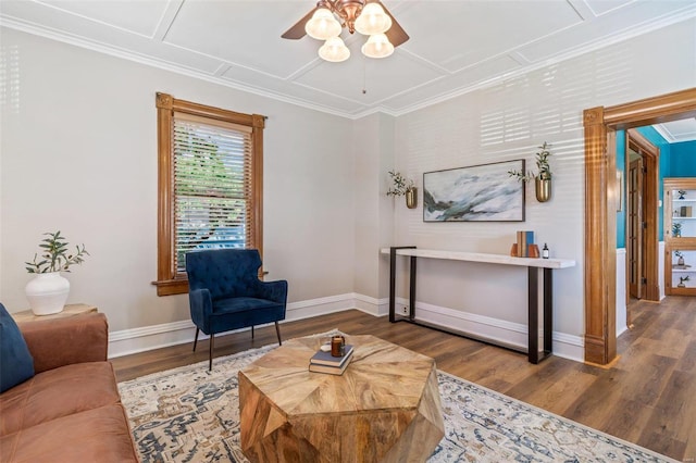 sitting room featuring ornamental molding, baseboards, and wood finished floors