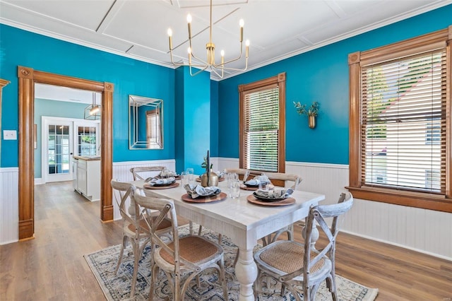 dining room with a wealth of natural light, wainscoting, and wood finished floors