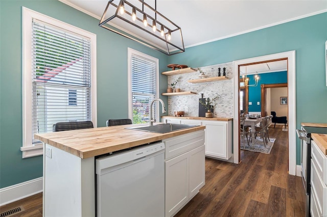 kitchen with visible vents, dishwasher, butcher block counters, ornamental molding, and a sink