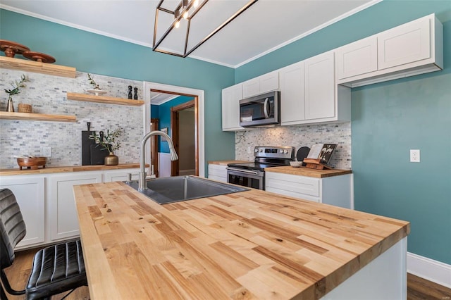 kitchen with stainless steel appliances, butcher block counters, a sink, white cabinets, and open shelves