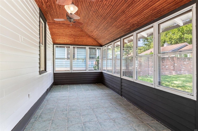 unfurnished sunroom featuring vaulted ceiling, ceiling fan, a wealth of natural light, and wood ceiling