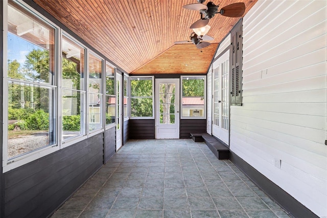 unfurnished sunroom featuring vaulted ceiling, wood ceiling, and ceiling fan