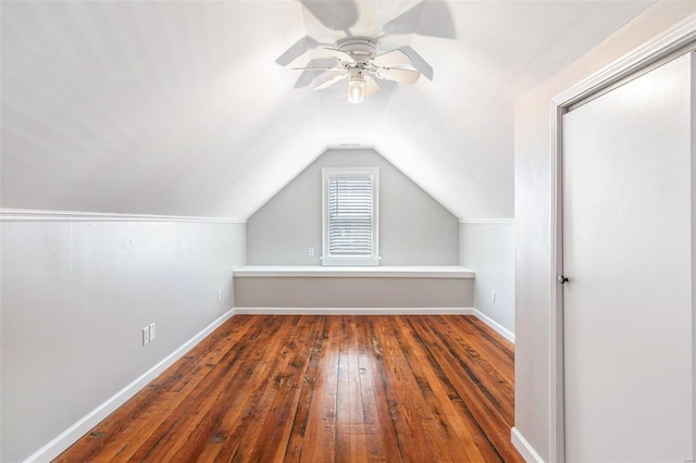 additional living space featuring vaulted ceiling, a ceiling fan, hardwood / wood-style flooring, and baseboards