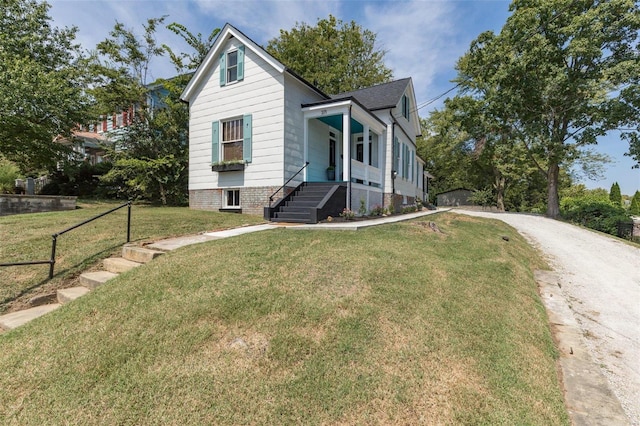 bungalow-style home featuring driveway, a front lawn, and fence