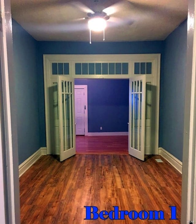 unfurnished bedroom featuring ceiling fan, wood-type flooring, and french doors