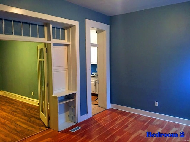 unfurnished bedroom featuring wood-type flooring