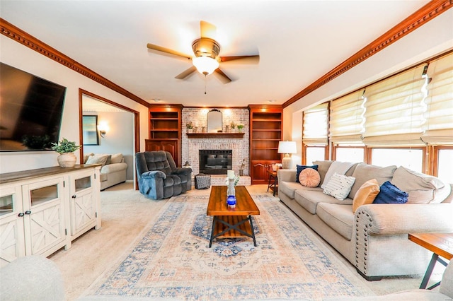 carpeted living room featuring a fireplace, crown molding, ceiling fan, and built in features